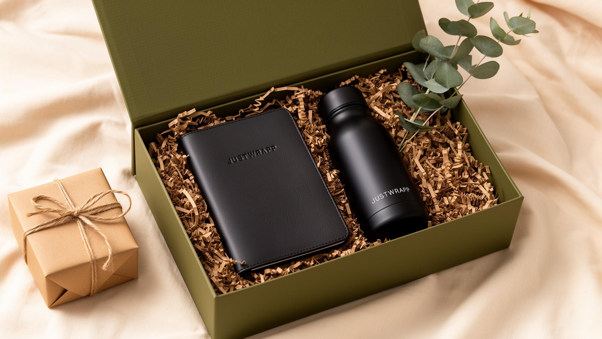 JustWrapp olive green gift box with leather notebook, matte black bottle and kraft-wrapped gift